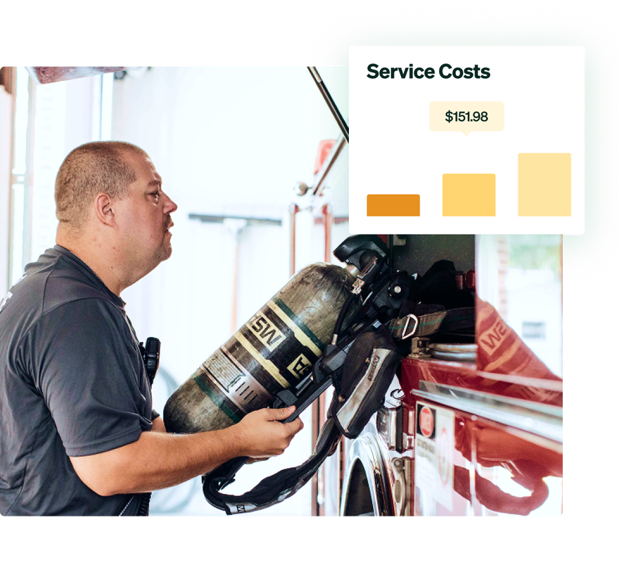 A firefighter inspecting a fire truck.